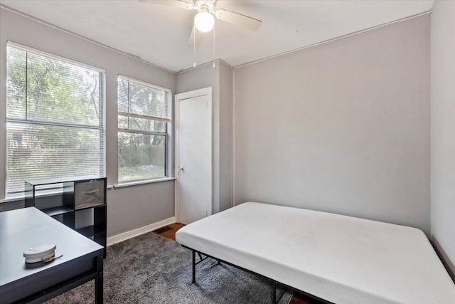 bedroom with ceiling fan and dark hardwood / wood-style floors