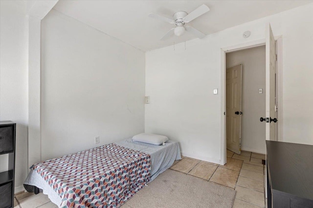 bedroom with ceiling fan and light tile patterned floors