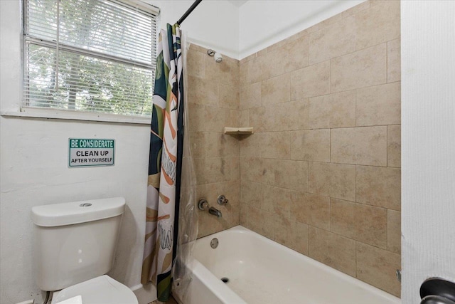 bathroom with shower / tub combo and toilet