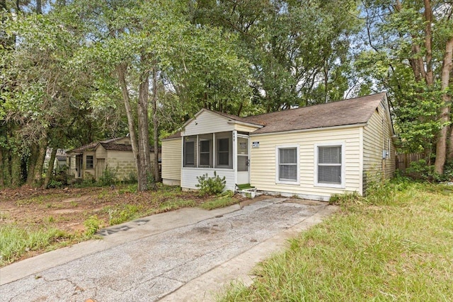 view of front of home featuring a sunroom