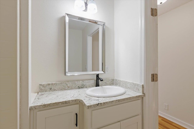 bathroom with vanity and hardwood / wood-style flooring