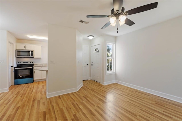 interior space with light hardwood / wood-style flooring and ceiling fan