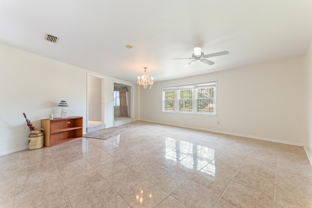 empty room featuring ceiling fan with notable chandelier, baseboards, and visible vents