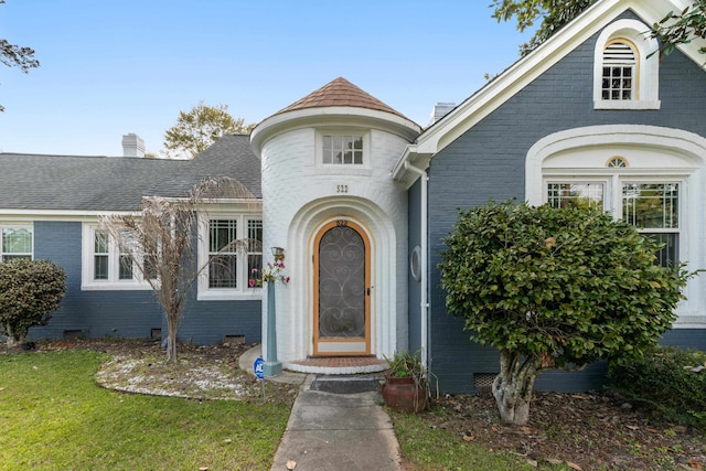 view of exterior entry featuring brick siding