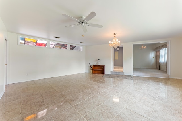 spare room with baseboards, light tile patterned flooring, visible vents, and ceiling fan with notable chandelier