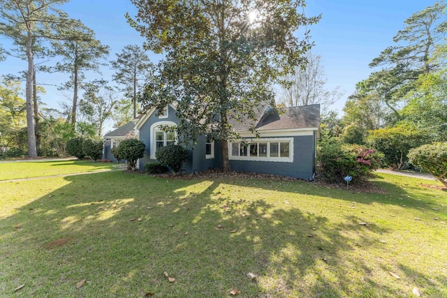 view of front of home with stucco siding and a front lawn