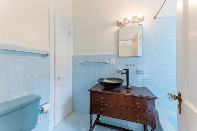 full bathroom featuring tile patterned flooring, vanity, toilet, and tile walls