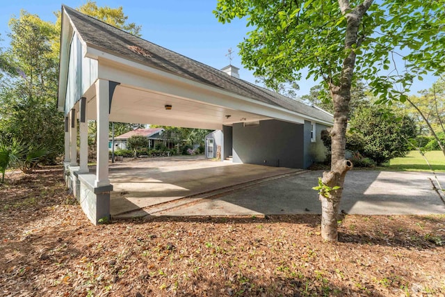view of car parking featuring driveway and a carport