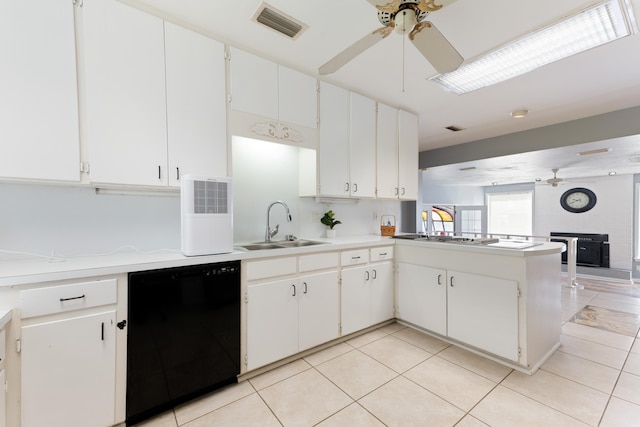 kitchen featuring light countertops, a sink, a ceiling fan, black dishwasher, and visible vents