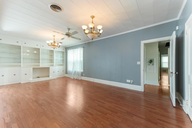 unfurnished living room with visible vents, crown molding, wood finished floors, and an inviting chandelier
