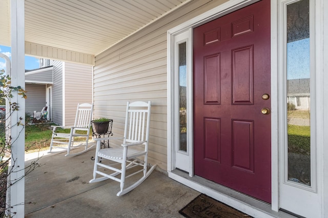 view of exterior entry featuring covered porch