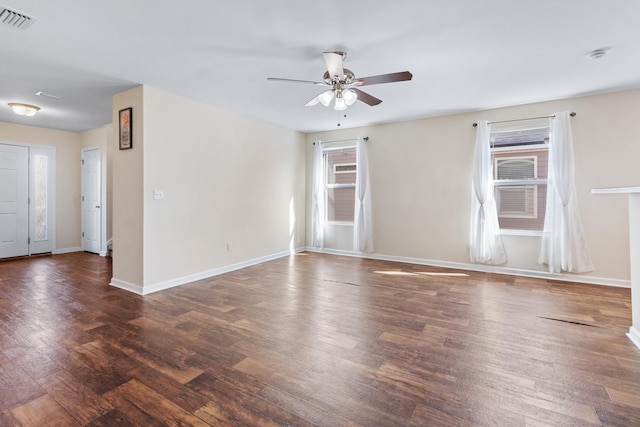 empty room featuring dark hardwood / wood-style flooring and ceiling fan