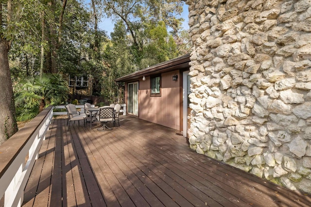 wooden deck featuring outdoor dining area