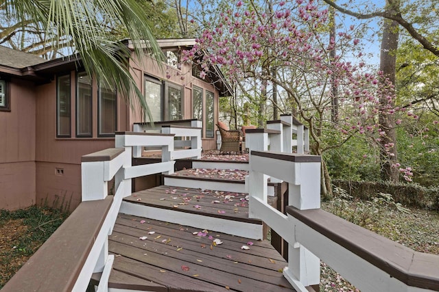 view of side of home with crawl space and a wooden deck