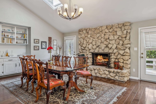 dining room with dark wood-style floors, plenty of natural light, an inviting chandelier, and vaulted ceiling