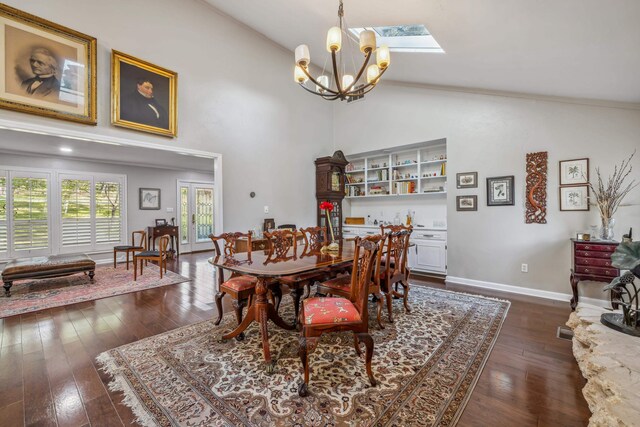 dining area featuring a skylight, baseboards, a chandelier, and dark wood-style flooring