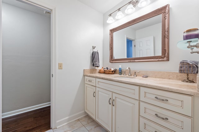 bathroom with tile patterned flooring, vanity, and baseboards