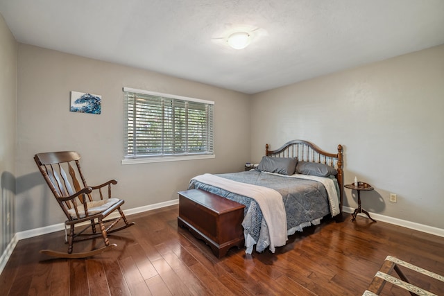 bedroom with baseboards and hardwood / wood-style floors