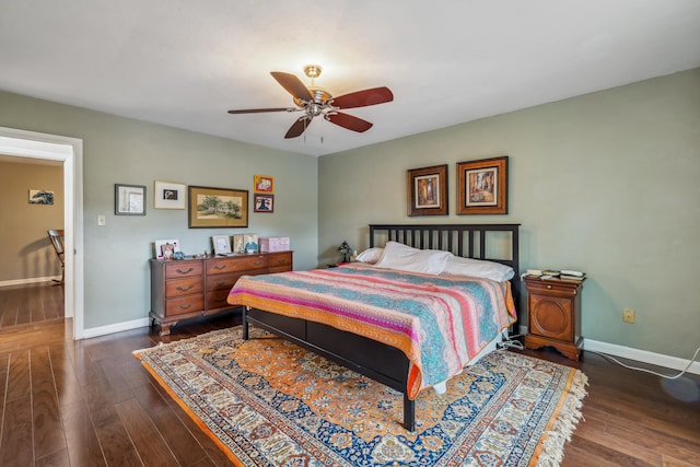 bedroom featuring baseboards, a ceiling fan, and hardwood / wood-style flooring