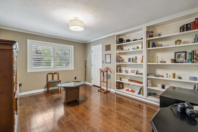 interior space featuring baseboards, built in shelves, dark wood-style flooring, and crown molding