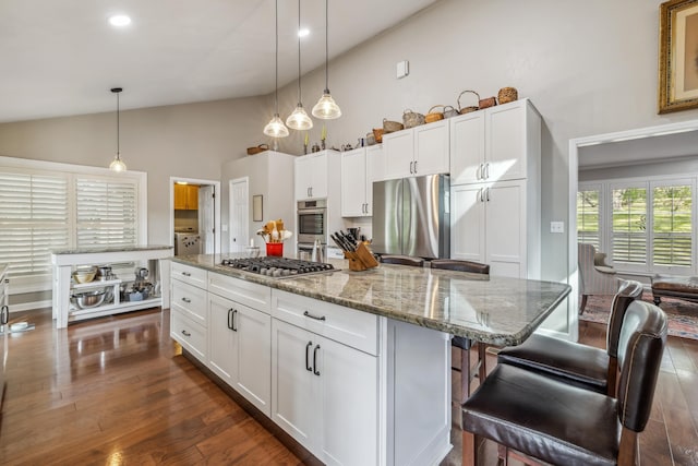 kitchen with decorative light fixtures, dark wood-style floors, appliances with stainless steel finishes, and white cabinets