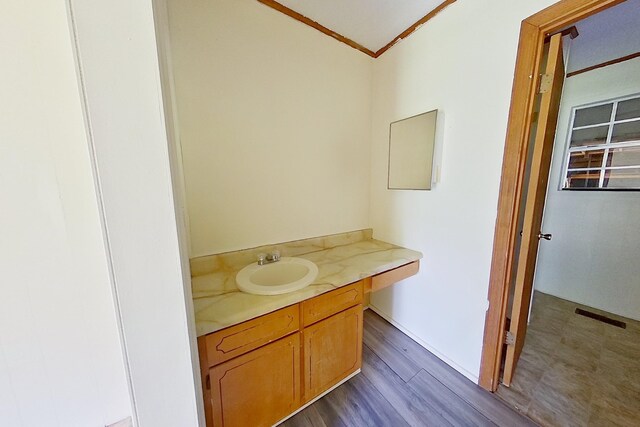 452-BN Railroad Cir, Boston, GA 31626 - bathroom with crown molding, vanity, and wood finished floors