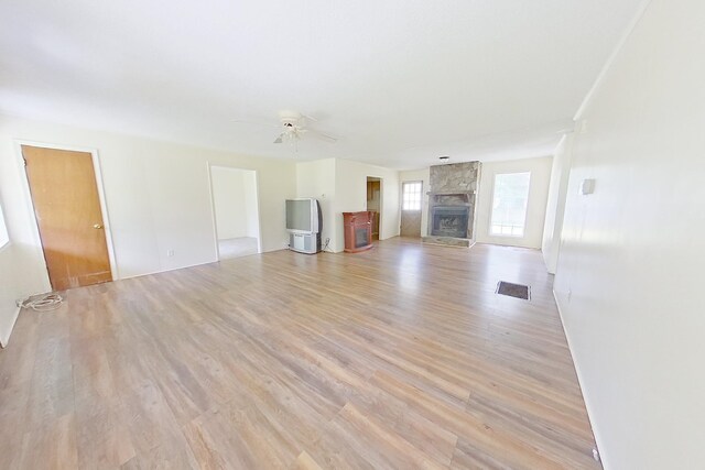 452-BN Railroad Cir, Boston, GA 31626 - unfurnished living room featuring light wood-type flooring, a fireplace, and a ceiling fan