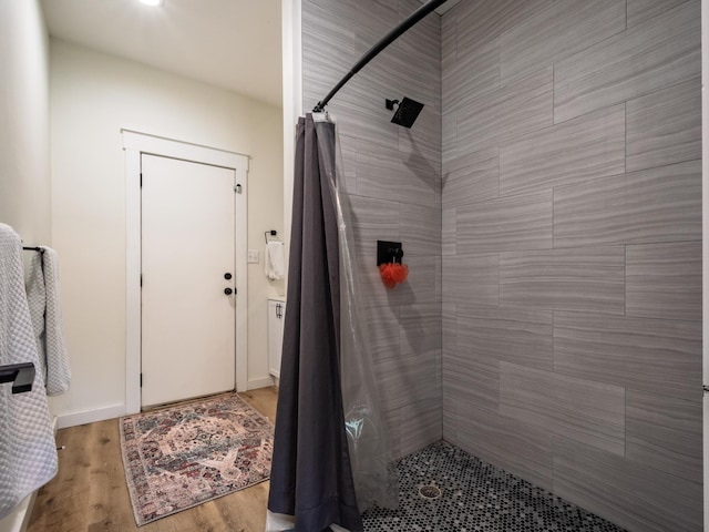 195 Coe Landing Rd, Tallahassee, FL 32310 - bathroom featuring wood finished floors, baseboards, and tiled shower