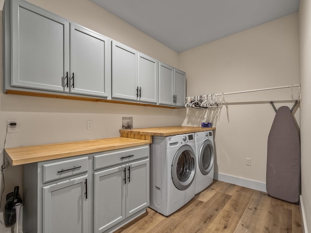 195 Coe Landing Rd, Tallahassee, FL 32310 - laundry room featuring separate washer and dryer, cabinet space, baseboards, and light wood-style floors