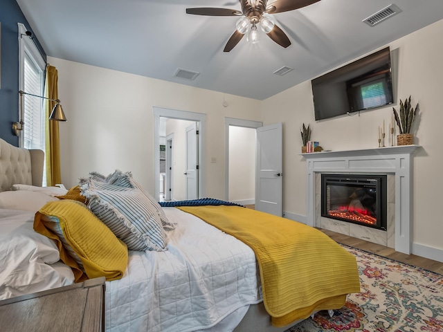 195 Coe Landing Rd, Tallahassee, FL 32310 - bedroom with visible vents, wood finished floors, and a glass covered fireplace