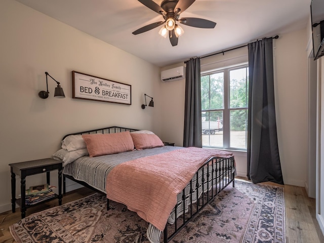 195 Coe Landing Rd, Tallahassee, FL 32310 - bedroom featuring wood finished floors, a ceiling fan, and an AC wall unit
