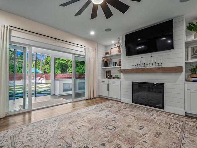 195 Coe Landing Rd, Tallahassee, FL 32310 - unfurnished living room featuring a wealth of natural light, light wood-style floors, a ceiling fan, and a large fireplace