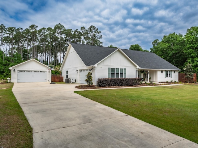 195 Coe Landing Rd, Tallahassee, FL 32310 - view of front of home with fence, board and batten siding, a front yard, and a detached garage