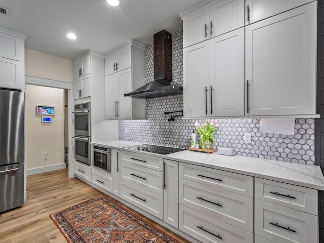 195 Coe Landing Rd, Tallahassee, FL 32310 - kitchen featuring stainless steel appliances, tasteful backsplash, visible vents, white cabinetry, and wall chimney range hood