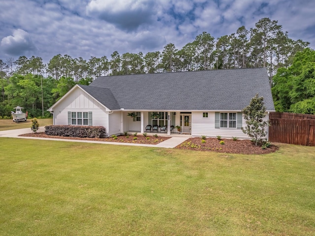 195 Coe Landing Rd, Tallahassee, FL 32310 - ranch-style home with a porch, a front yard, a shingled roof, board and batten siding, and fence