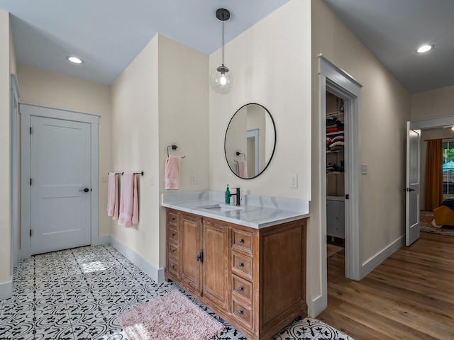 195 Coe Landing Rd, Tallahassee, FL 32310 - bathroom with baseboards, recessed lighting, a spacious closet, and vanity