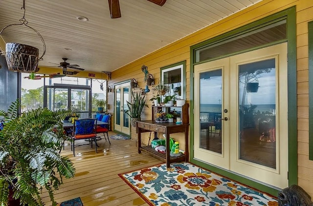 sunroom / solarium featuring ceiling fan and wooden ceiling