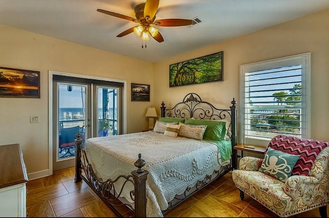 bedroom featuring multiple windows, access to outside, french doors, and ceiling fan