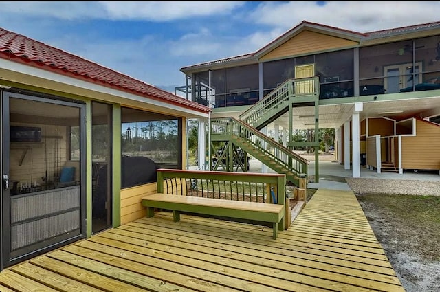 wooden terrace featuring a sunroom