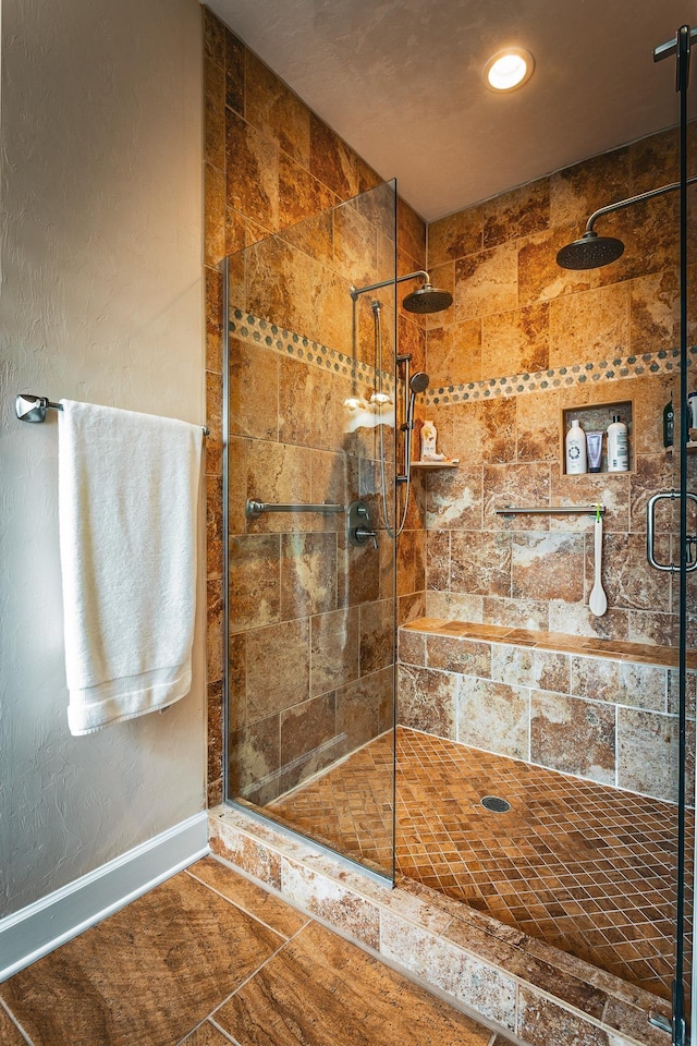 bathroom with tiled shower