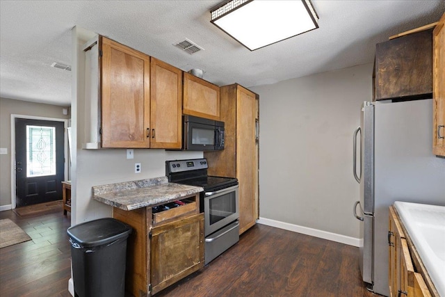 127 E Nancy St, Perry, FL 32347 - kitchen featuring stainless steel appliances, dark wood finished floors, and baseboards