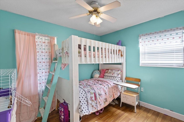 127 E Nancy St, Perry, FL 32347 - bedroom with baseboards, wood finished floors, and a ceiling fan