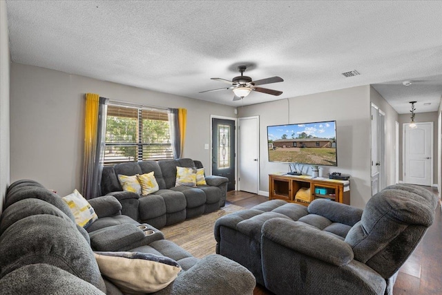 127 E Nancy St, Perry, FL 32347 - living area with a textured ceiling, wood finished floors, ceiling fan, and visible vents