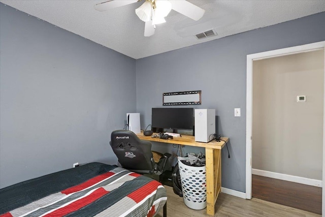 127 E Nancy St, Perry, FL 32347 - bedroom with wood finished floors, a ceiling fan, visible vents, and baseboards