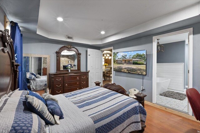 127 E Nancy St, Perry, FL 32347 - bedroom with recessed lighting, visible vents, wood finished floors, and a tray ceiling
