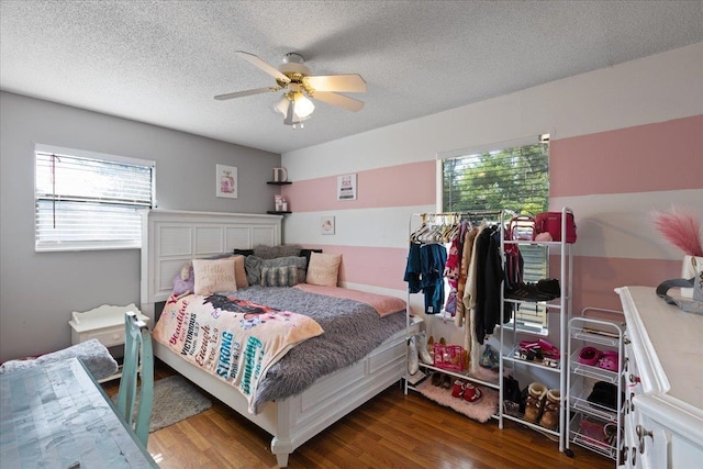 127 E Nancy St, Perry, FL 32347 - bedroom with a textured ceiling, wood finished floors, and multiple windows