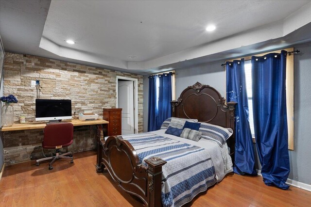 127 E Nancy St, Perry, FL 32347 - bedroom featuring baseboards, recessed lighting, wood finished floors, and a tray ceiling