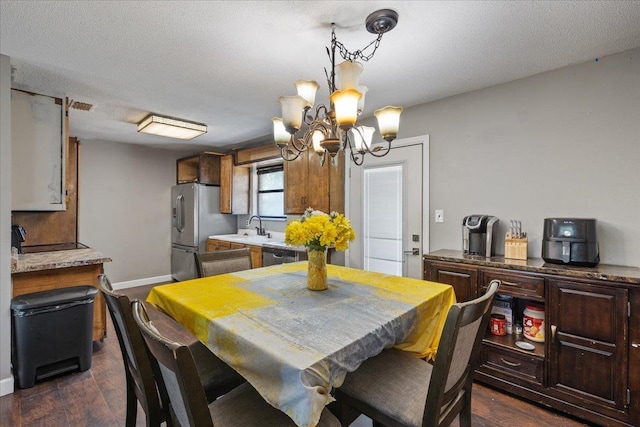 127 E Nancy St, Perry, FL 32347 - dining area with a notable chandelier, dark wood-style floors, and baseboards