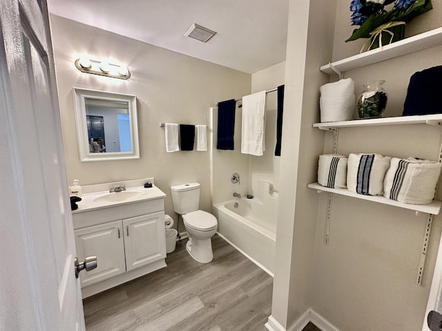 3180 N Ridge Rd -, Unit Tallahassee, FL 32305 - bathroom featuring visible vents, vanity, wood finished floors, toilet, and baseboards
