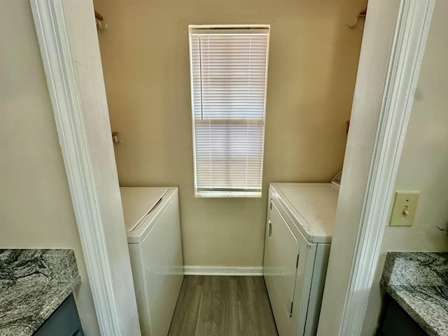 3180 N Ridge Rd -, Unit Tallahassee, FL 32305 - washroom with laundry area, baseboards, wood finished floors, and washer and dryer